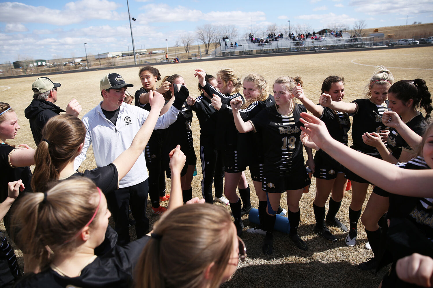 Cameron Spade, left, huddles with the team at the end of halftime